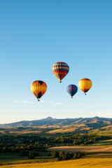 Obraz premium Colorful Hot Air Balloons Soar Over Rolling Hills