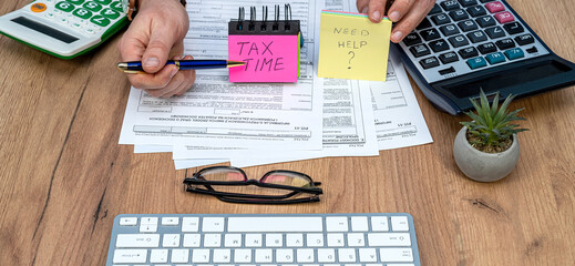 Accountant filling Polish tax forms at home, taxation concept. PIT