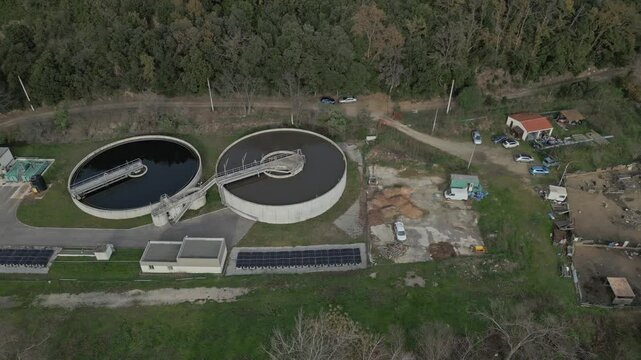 Modern water treatment facility actively purifying water near amelie les bains palalda, france, showcasing circular filtration tanks and solar panels for sustainable operation