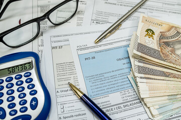 PIT-38 PIT 37 empty form, annual tax return to the tax office, zloty money calculator pen glasses