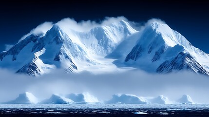 Majestic snowy mountains pierce the sky above a sea of fog and icebergs creating an arctic landscape