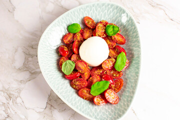 Farmer Italian soft cheese mozzarella served with fresh basil and red cherry tomatoes