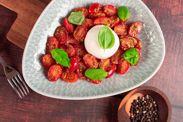Farmer Italian soft cheese mozzarella served with fresh basil and red cherry tomatoes