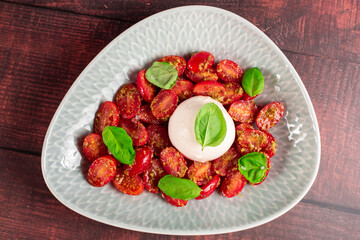 Farmer Italian soft cheese mozzarella served with fresh basil and red cherry tomatoes