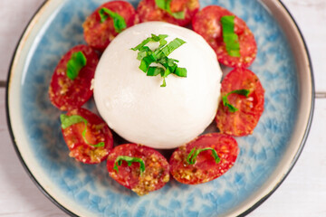 Farmer Italian soft cheese mozzarella served with fresh basil and red cherry tomatoes