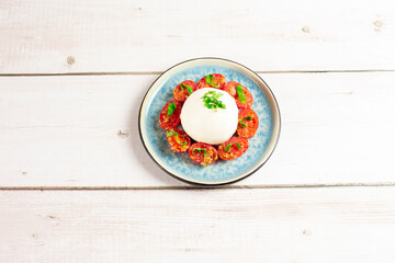 Farmer Italian soft cheese mozzarella served with fresh basil and red cherry tomatoes