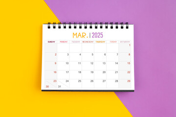 March 2025 Monthly desk calendar for 2025 year on yellow and purple.