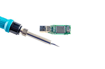 Soldering iron in the hands, repairs a damaged flash drive, on a white background
