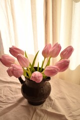 Clay vase with pink tulips