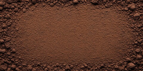 Dark Brown Soil Texture: Rich, dark brown soil forms a natural frame, showcasing its fine texture and earthy tones. Perfect for backgrounds or agricultural themes.