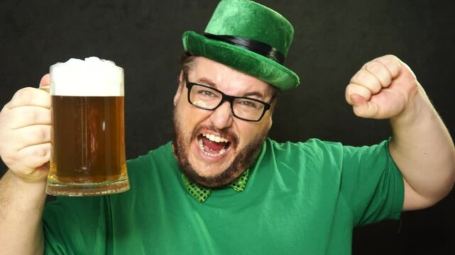 Funny fat man in green kilt drinking beer. Holidays and weekends.