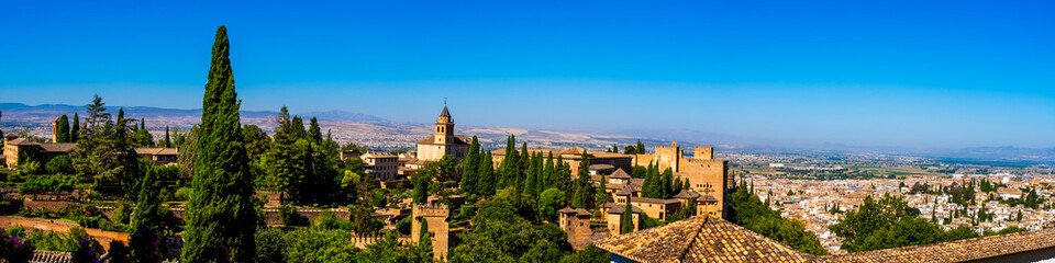 Alhambra’s Timeless Grandeur at Noon: A Panoramic View of Granada’s Iconic Fortress and Vibrant Cityscape