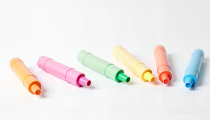 Colorful highlighters arranged in a row on white background with copy space