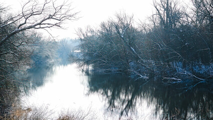 Snow river winter landscape. Frozen ice and snow by river.