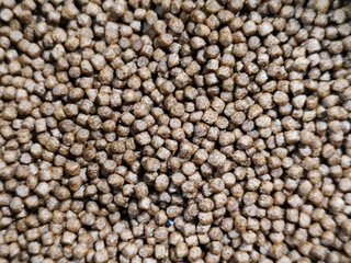 Fish concentrate is round in shape. Fish feed concentrate background.