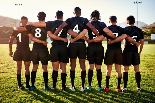 Men, back or rugby team standing in stadium for sports game, group or challenge on field together. Professional, ready or legs of players in line or row for respect, unity or tournament competition