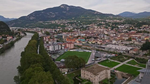 Aerial drone view of Trento, Italy, showcasing its historic cityscape , and the surrounding alpine landscape of the Trentino region.