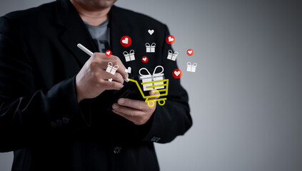 businessman uses stylus on smartphone, interacting with floating digital icons shopping cart, gift,...