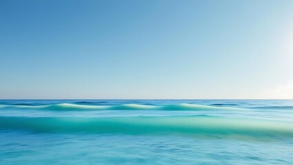 Fototapeta premium Gentle ocean waves under a clear blue sky with light blue and turquoise gradients creating a peaceful vibe.