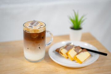 glass of ice coffee on wooden table