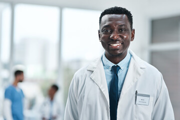 Portrait, black man and doctor with smile at hospital of healthcare services, medical advice and trust. Happy, person and ambition with about us, diagnosis and health insurance for wellness treatment