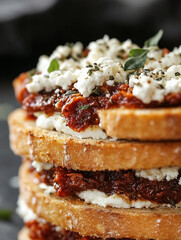 Macro close-up photo of a toasted sandwich with sourdough bread with sun-dried tomatoes, goat cheese and oregano. 