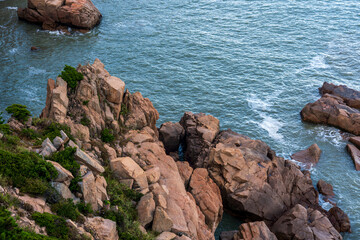 Serene Coastal View of Rocky Outcrops and Calm Waters