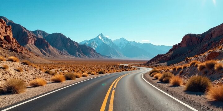Asphalt ribbon unwinding through a sun-drenched desert landscape, towards majestic snow-capped mountains under a vibrant sky