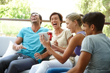 Fototapeta premium Tablet, laugh and group of people in home with online gambling games cheering for winning. Excited, digital technology and sports fans reading soccer score for match with goal at gathering in house.