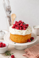 Homemade classic victoria vanilla sponge cake or biscuit or pie decorated with whipped cream and fresh strawberries on top on a light background. Summer dessert. Copy space. Selective focus.