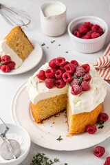 Homemade classic victoria vanilla sponge cake or biscuit or pie decorated with whipped cream and fresh strawberries on top on a light background. Summer dessert. Copy space. Selective focus.