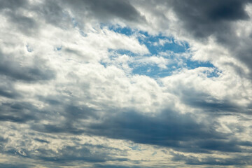 Blue sky, clouds, background, beautiful landscape with heavy thunderclouds. Nature waiting for storm