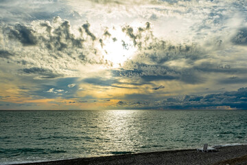 Picturesque sunset over the sea with dramatic clouds creating an unusual intriguing image. Black Sea end of summer