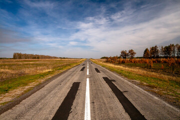 Endless Open Road: A Scenic Highway Stretching into the Horizon under a Clear Blue Sky on autumn 