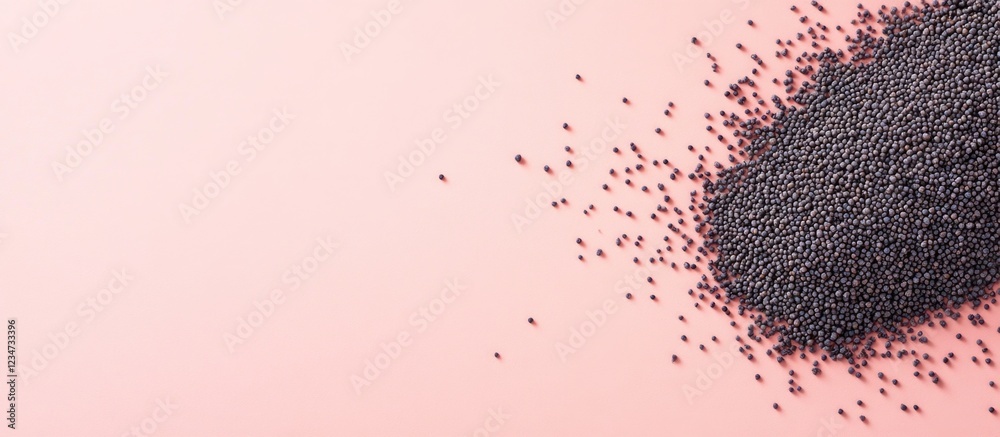 Wall mural black seeds scattered on a pink background with ample copy space for text placement