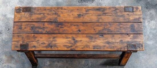 Wooden Table with Rustic Finish and Metal Corner Brackets on Textured Concrete Background Copy Space