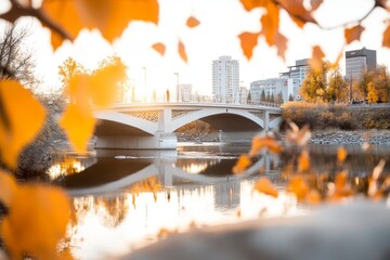 Fototapeta premium A substantial bridge spanning a wide river, with cars and pedestrians crossing in the golden light of sunset