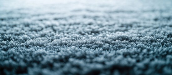 Textured close-up of soft blue carpet fibers with shallow depth of field and copy space for text placement