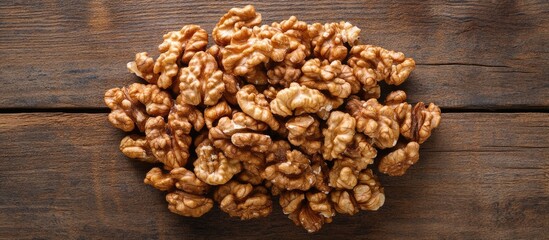 Obraz premium Walnuts in a pile on rustic wooden surface with natural lighting Copy Space
