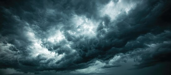 Dramatic dark storm clouds forming ominously in a moody sky with potential for weather changes Copy Space