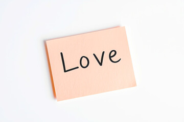 Text Love on pink note on white background