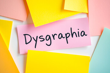 Flat lay of colorful notes with text Dysgraphia on pink note