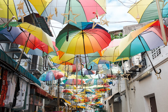Beautiful and colorful umbrellas hanging above at George Town, Penang Island, Malaysia. One of favorite photo spot for tourist. Perfect as background or travel wallpaper