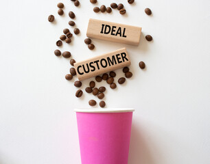 Ideal Customer symbol. Concept word Ideal Customer on wooden blocks. Beautiful white background with coffee cup. Business and Ideal Customer concept. Copy space