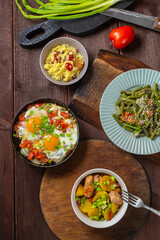 A set table, tzimmes, chelnt, shakshuka and couscous