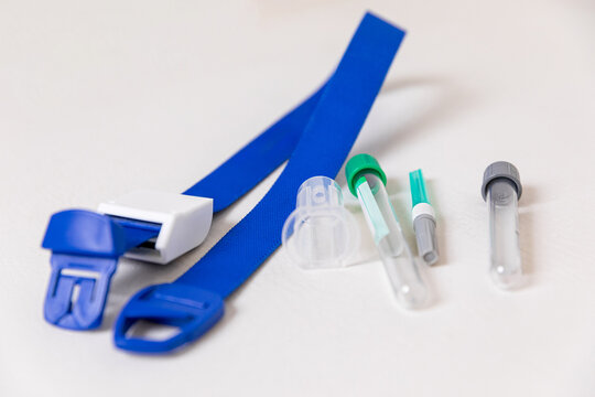 Medical instruments background with suringe, bandage, tourniquet, test tube, sterilizer after taking blood from vein isolated on white background. Blood donation concept.