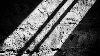 Dramatic light and shadow interplay on a rough stone wall creates an abstract geometric pattern, ideal for backgrounds and textures