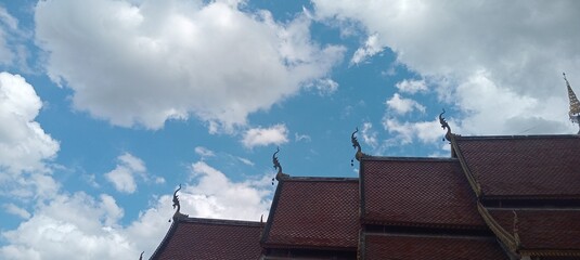 A top view over the roof of temple with clouds over the sky