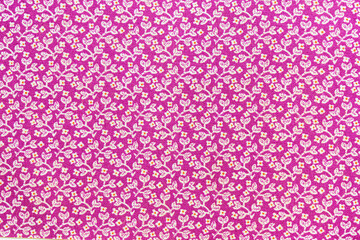 Purple fabric background featuring small white floral pattern