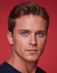 Obraz premium Close-up portraits of a blue-eyed man with various expressions and lighting backgrounds. The series emphasizes facial features, symmetry, and eye color against red and blue backgrounds.